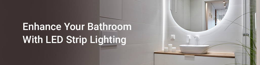 Adjusting a frosted glass light fixture above a bathroom mirror for maintenance.