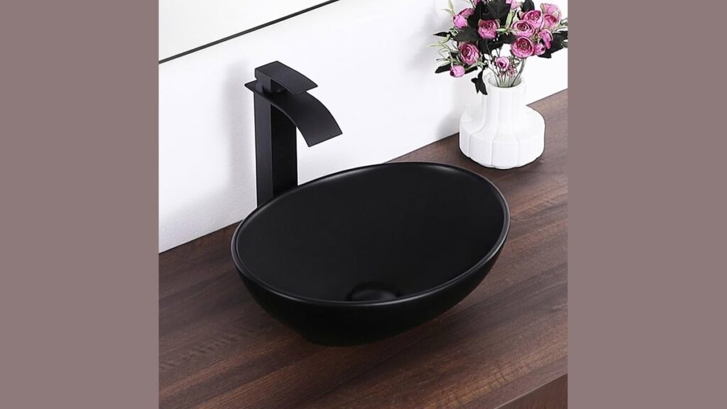 A modern bathroom sink with clean lines sits on a floating wood vanity.