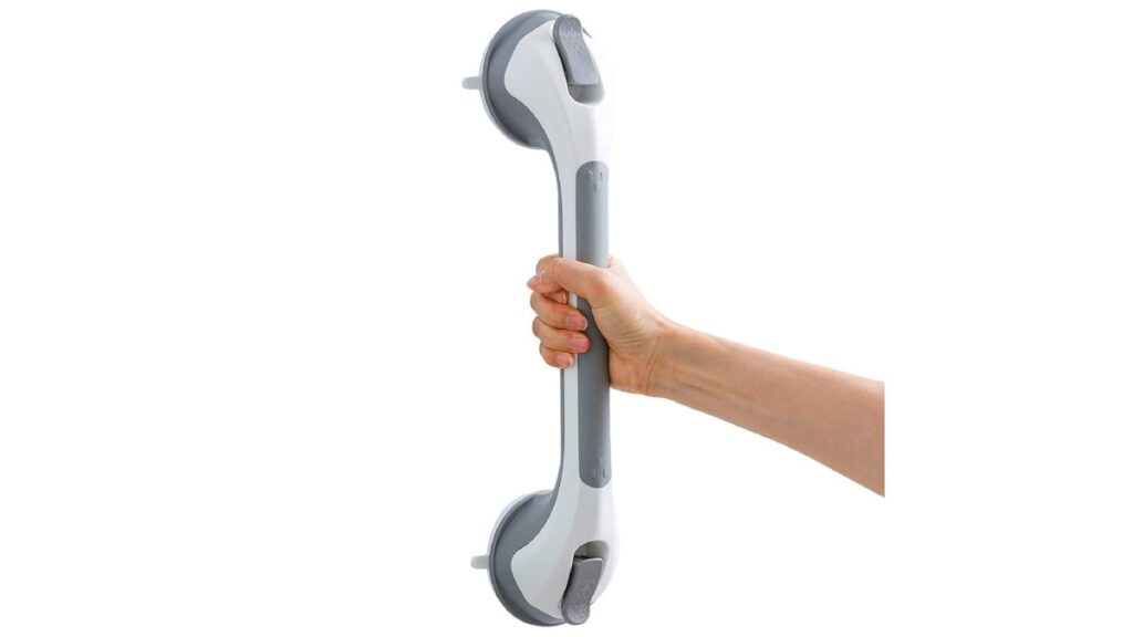 A modern, secure suction grab bar attached to white bathroom tiles.