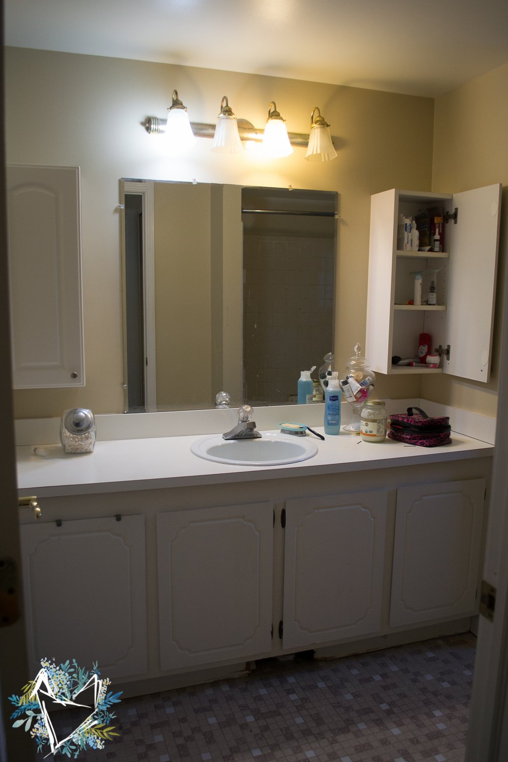 A person checking paint samples against a bathroom vanity while following a guide.
