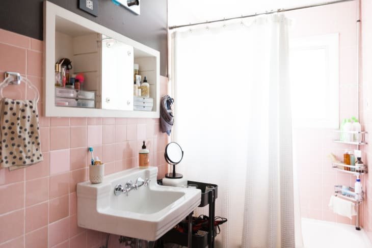 A securely installed towel rack holding a towel clear of the wall.