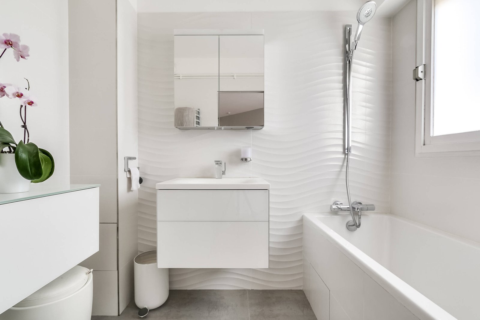 A perfectly leveled small bathroom mirror reflecting outdoor light to enhance room depth.