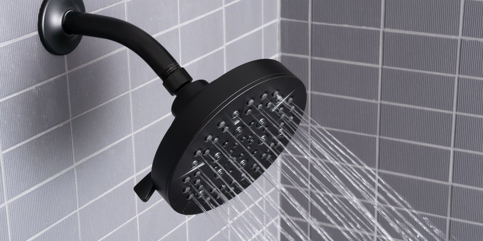 Installing a dual shower head system with a brass diverter valve.