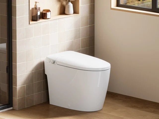 Close up of a hand holding a smart toilet remote near the water valve.