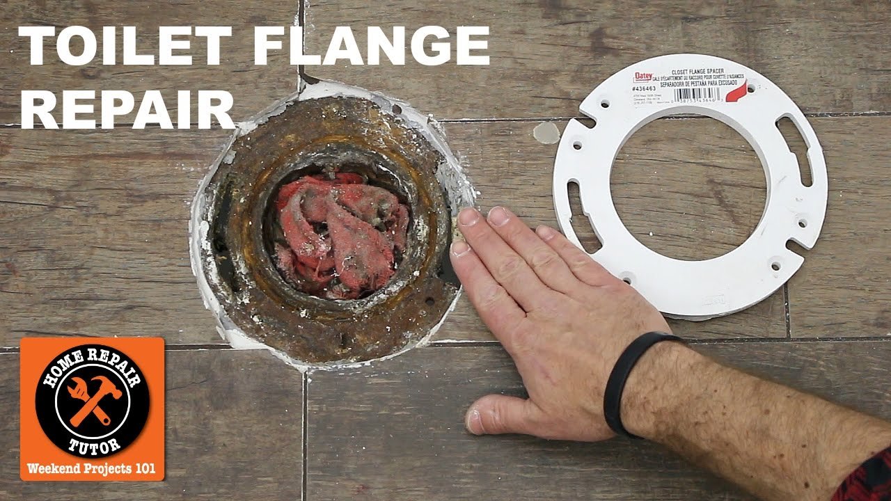 Using a coin to check the depth of a toilet flange installation.
