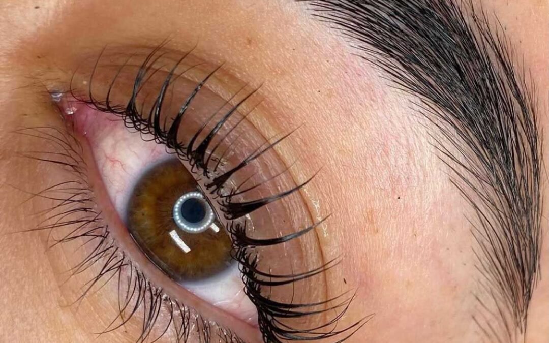 A person resting comfortably while waiting for their lash lift setting time to finish.