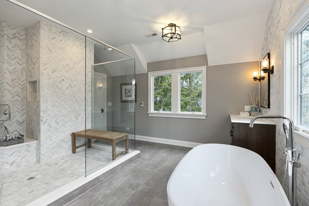 A modern small bathroom remodel project showing organized materials and exposed wall studs.