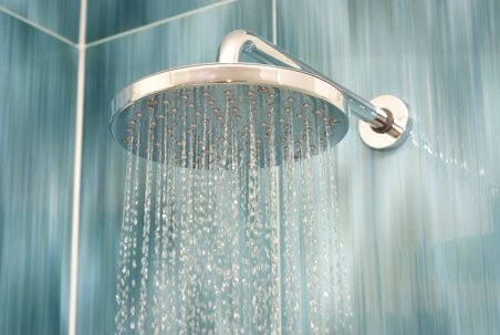 Clean bathroom vanity fixtures highlighting common questions about home hot water usage.