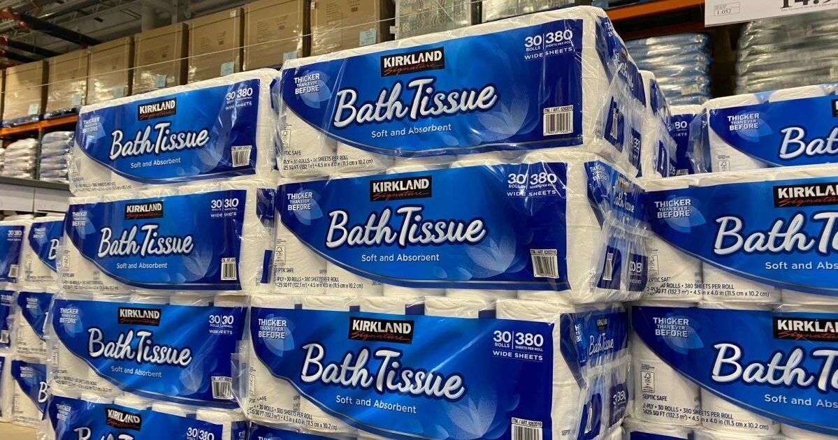 A close up of a bulk toilet paper package sitting on a warehouse pallet.