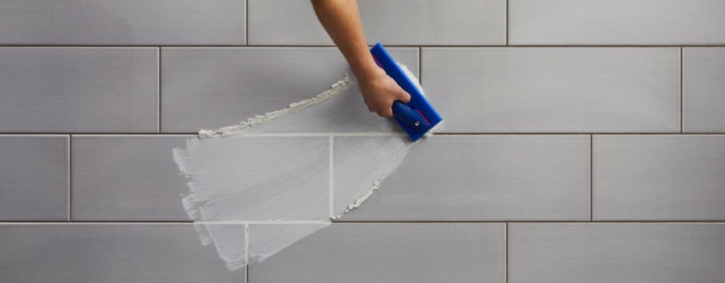A close-up view of clean, white shower tile grout in a modern bathroom.