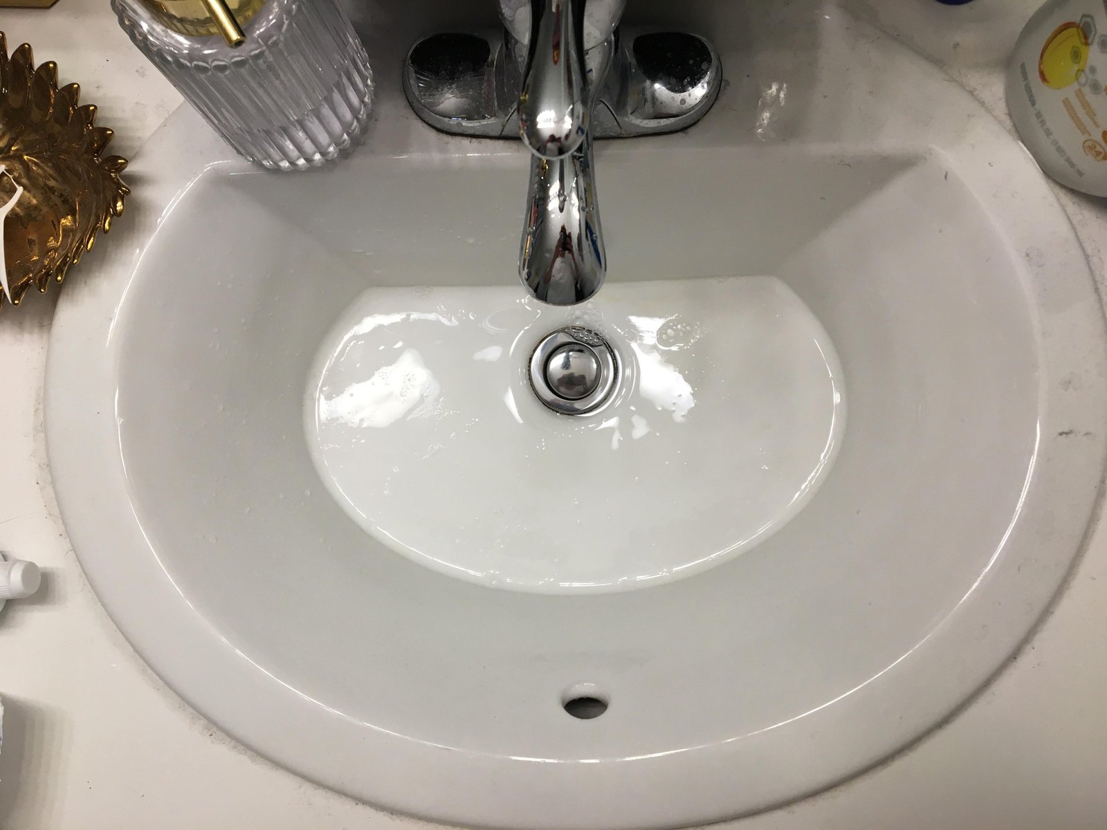 Close up of a bathroom sink drain showing buildup that causes unpleasant odors.