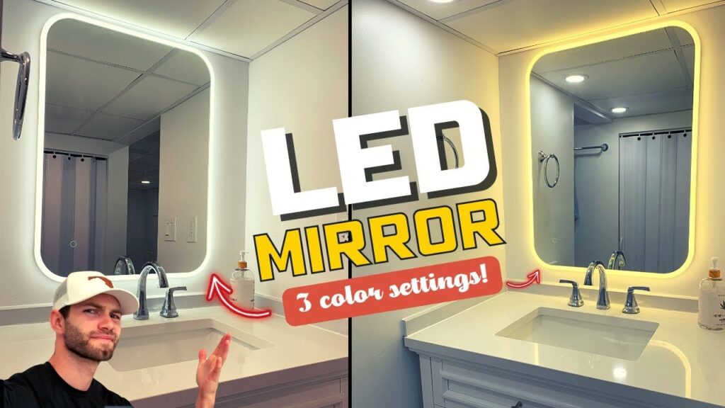 A modern illuminated bathroom vanity mirror installed above a clean marble sink countertop.