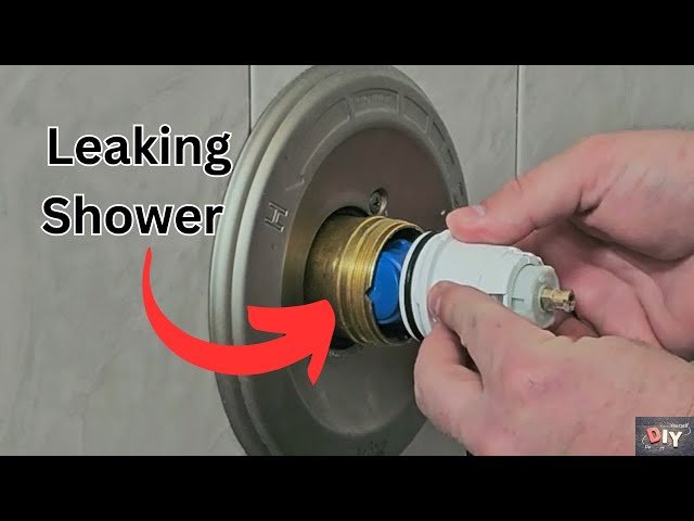A person carefully performs a shower cartridge replacement on a modern bathroom faucet.