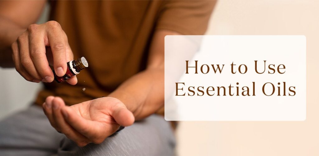 A collection of essential oils and fresh herbs arranged on a wooden table.