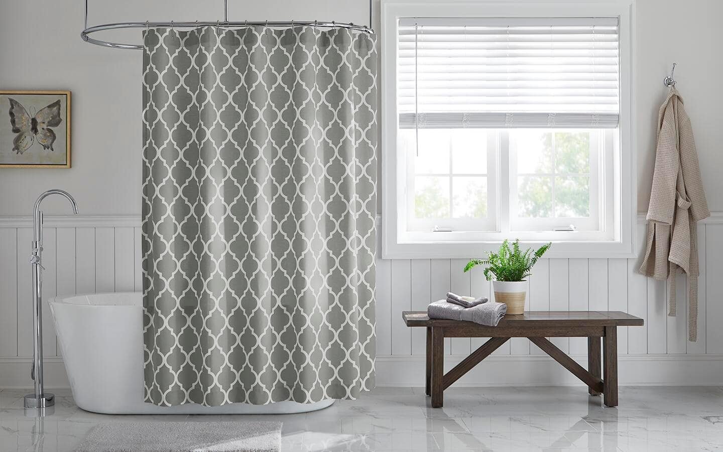 Moisture and soap scum collect on the bottom of a shower curtain.