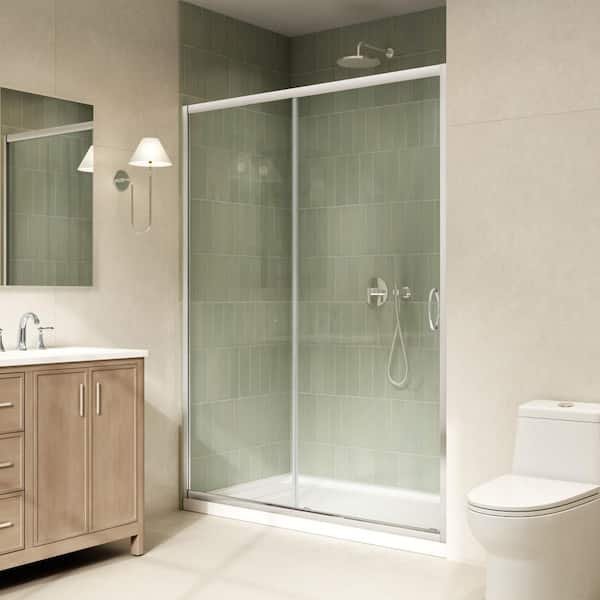 Hands using a spirit level to align the top rail of a glass shower door.
