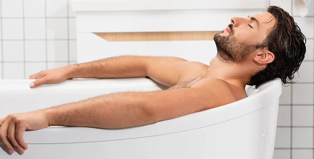 Mineral crystals dissolving in warm bath water to promote muscle relaxation.