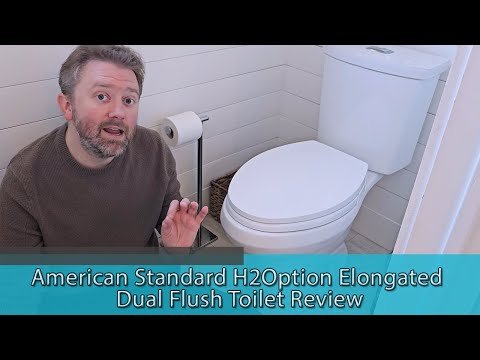Hands performing maintenance on the internal mechanism of a dual flush toilet tank.
