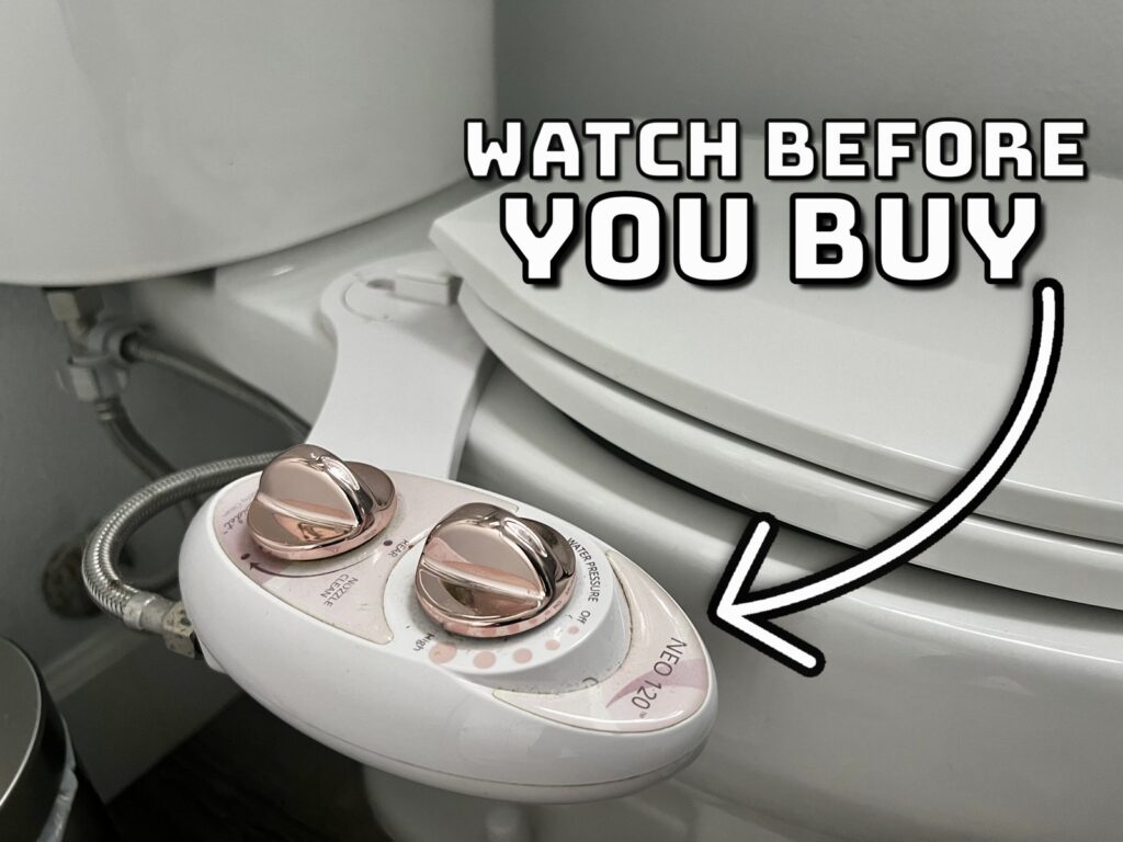 A modern Luxe Bidet Neo 120 installed on a clean white bathroom toilet.