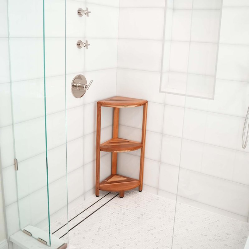 An efficient corner shower caddy neatly organizing toiletries within a small, modern shower stall.