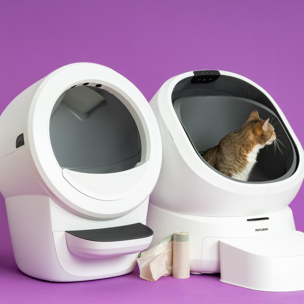 Maintenance being performed on a self-cleaning litter box to fix a sensor.