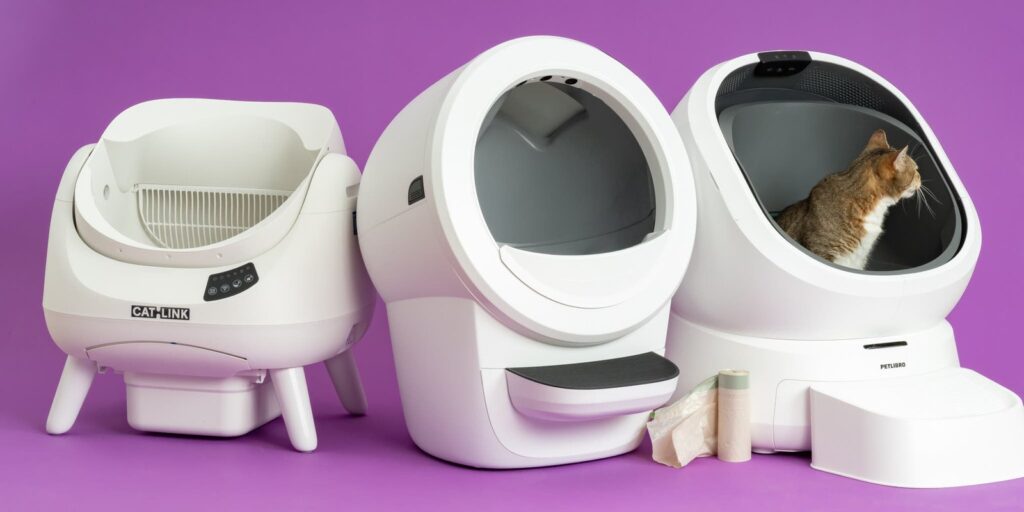 A modern self-cleaning litter box in a bright home for multiple cats.