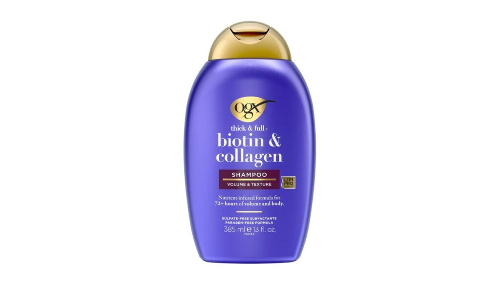 A bottle of biotin and collagen shampoo displayed on a marble countertop.
