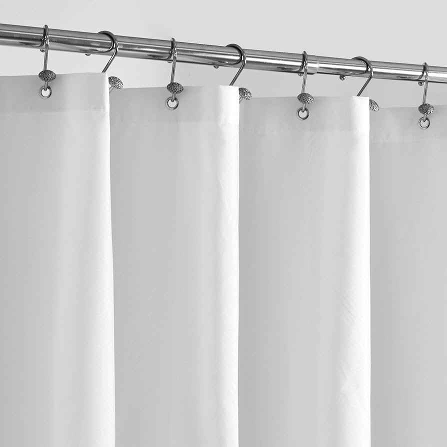 A neatly folded fabric shower curtain ready for a machine wash cycle.
