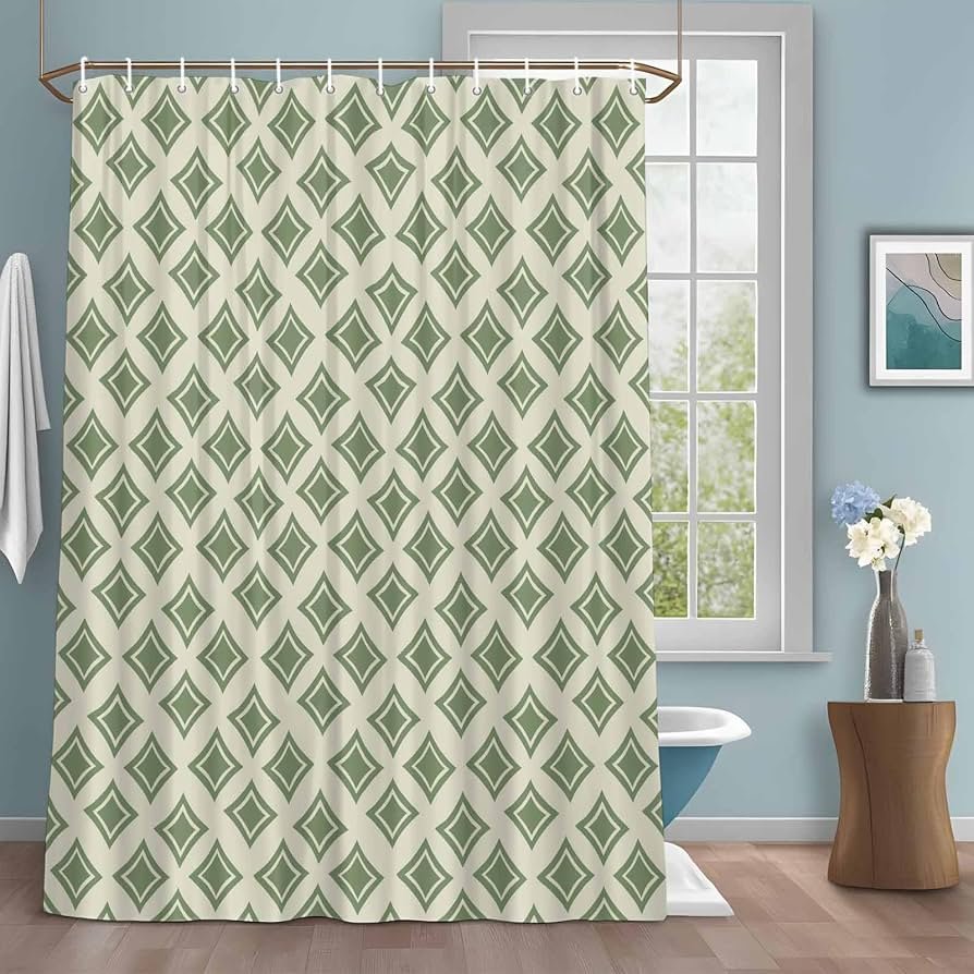 Neatly folded shower curtains displayed on a marble counter for a home decor guide.