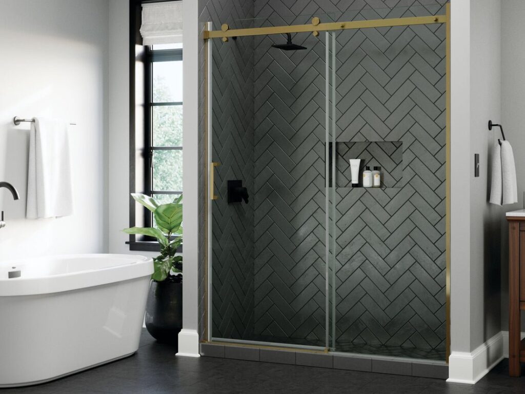 A modern glass shower door assembly showing a smooth roller on a metal track.