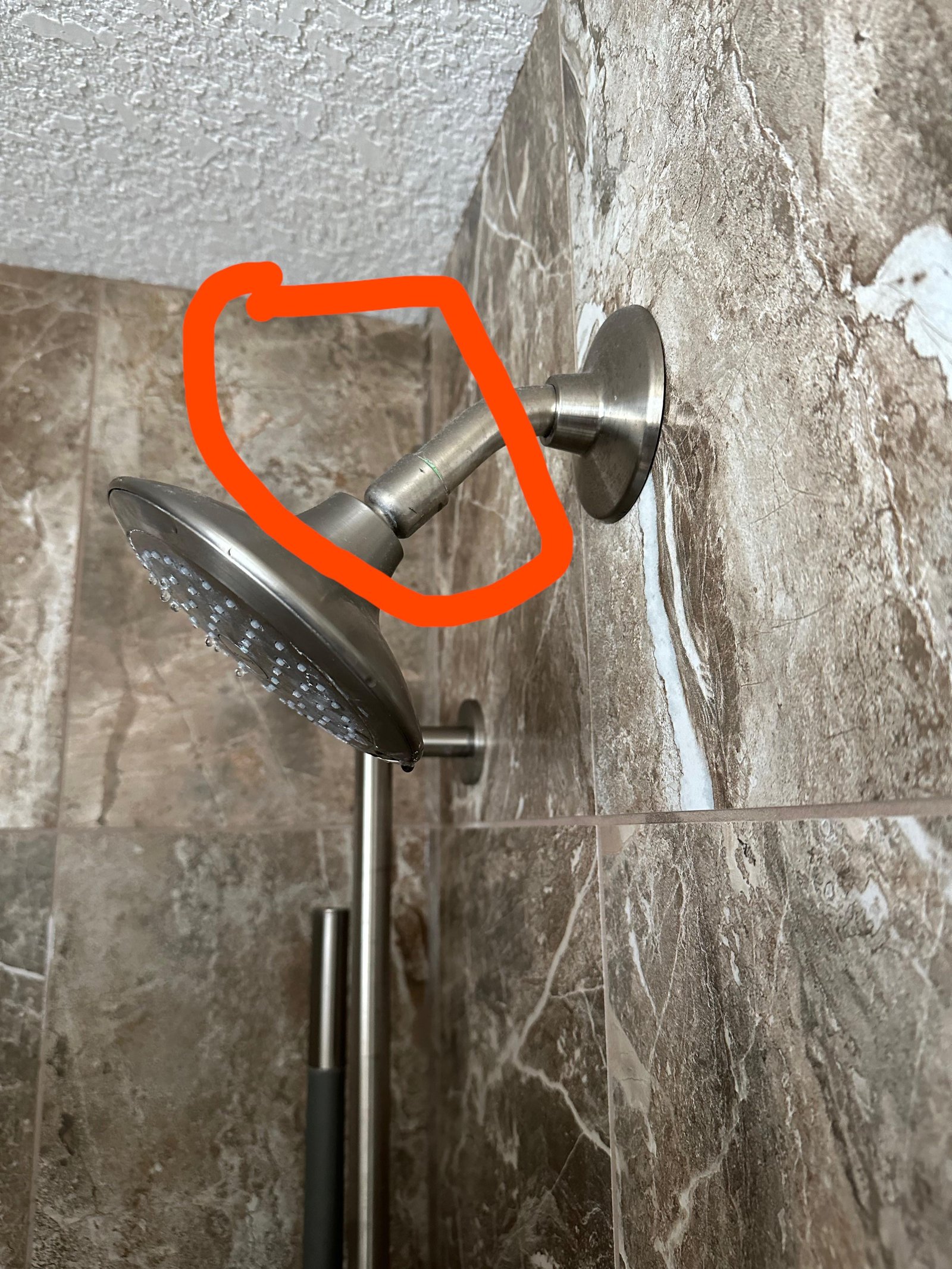 Plumbing tools and replacement parts laid out for shower head repair questions.