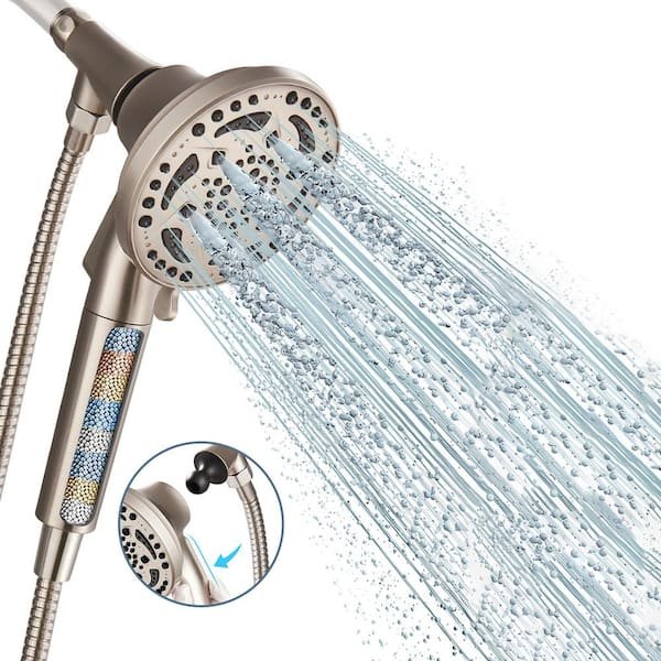 A smooth vinyl shower hose attached to a diverter valve in a bathroom.