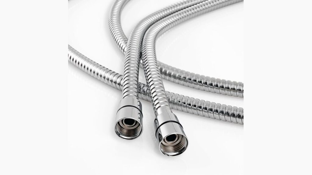 A modern handheld shower head and flexible hose in a clean, bright bathroom.