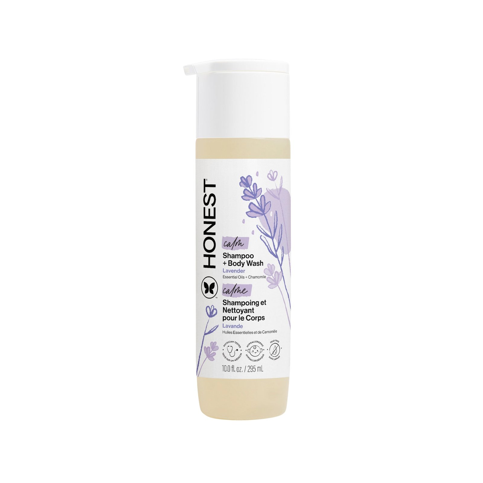 Multiple bottles of The Honest Company shampoo and body wash on a wooden shelf.