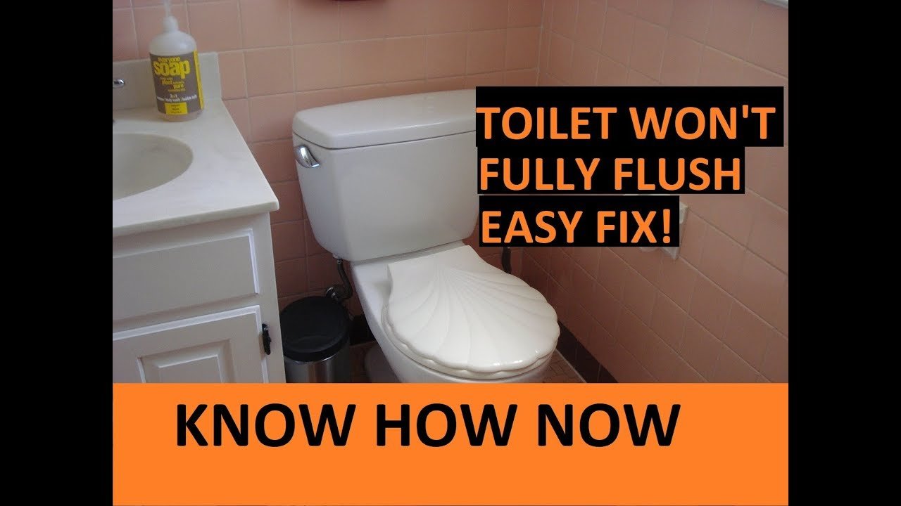 Using a wire tool to clear mineral deposits from toilet rim jets.
