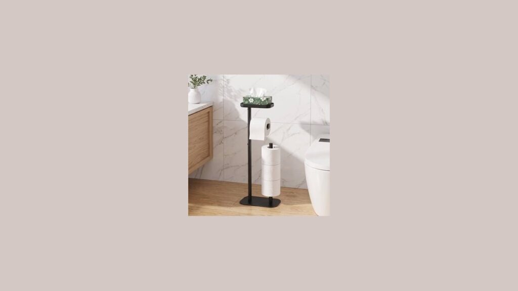 A modern toilet paper holder with shelf holding a smartphone in a bathroom.
