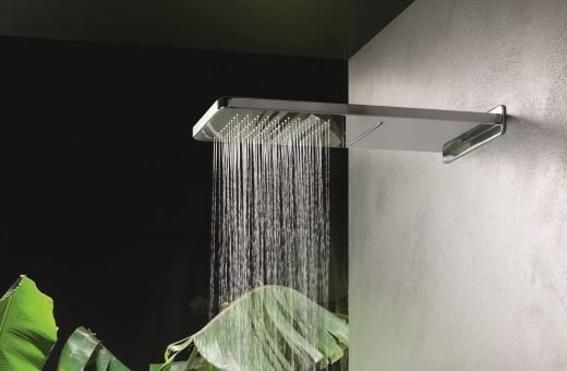 A professional installing a freestanding bathtub in a modern bathroom under renovation.