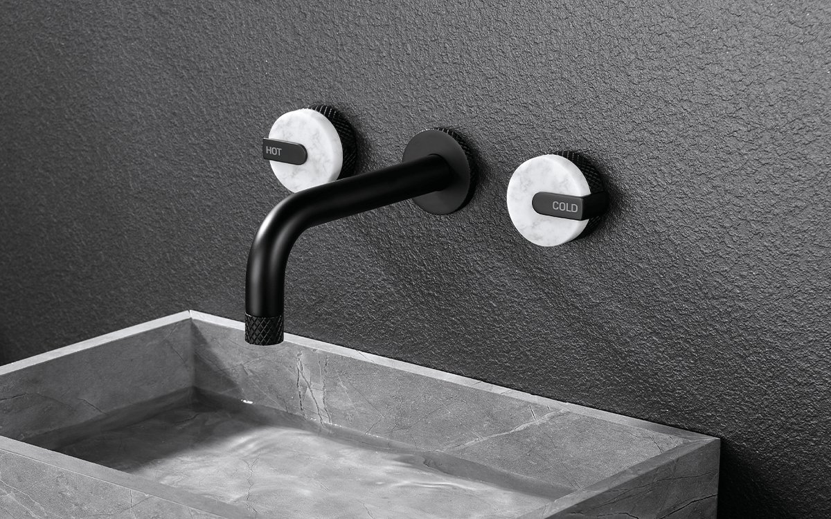 A selection of different faucet styles and handles displayed on a vanity for planning.