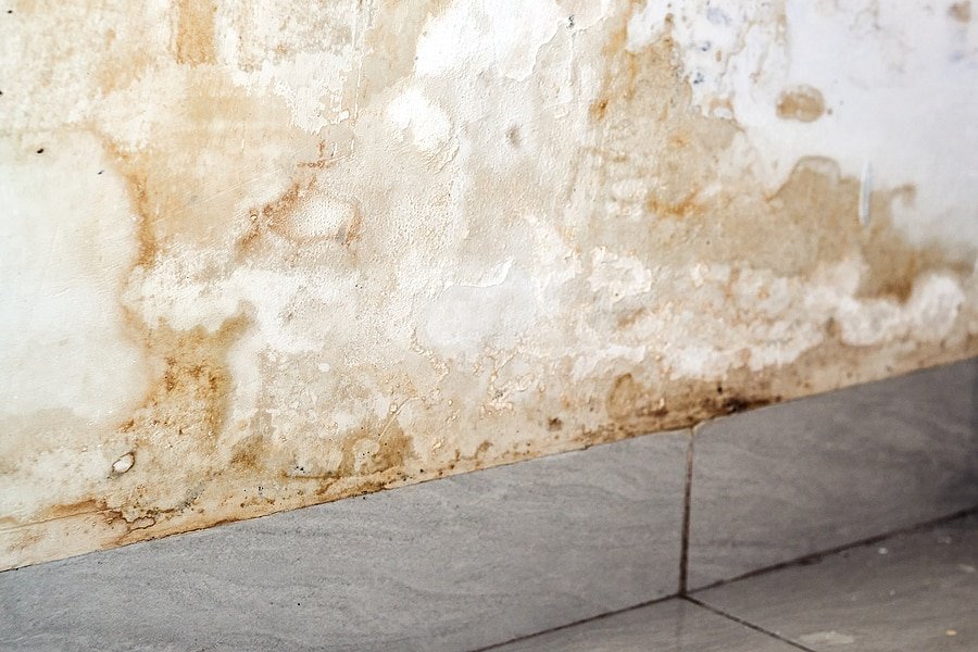 Cleaning a yellow surfactant water stain from a modern bathroom wall.