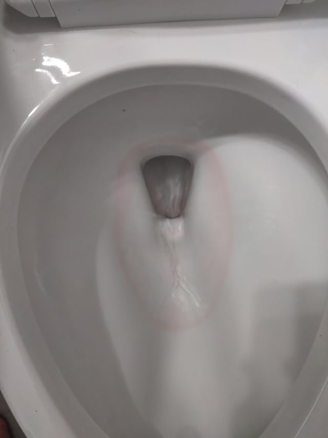 A white paper towel showing a reddish-brown mineral stain from a sink.