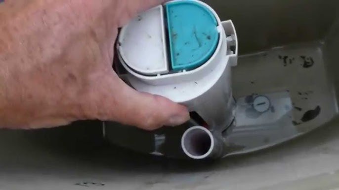 Close up of a hand near a dual flush button to show potential mechanical wear.