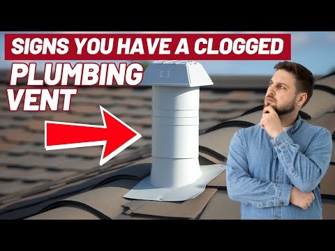A professional plumber using a drain snake to resolve a toilet plumbing blockage.