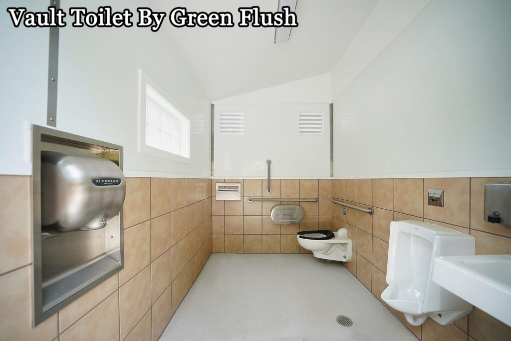 A modern vault toilet facility situated in a scenic, wooded natural park area.