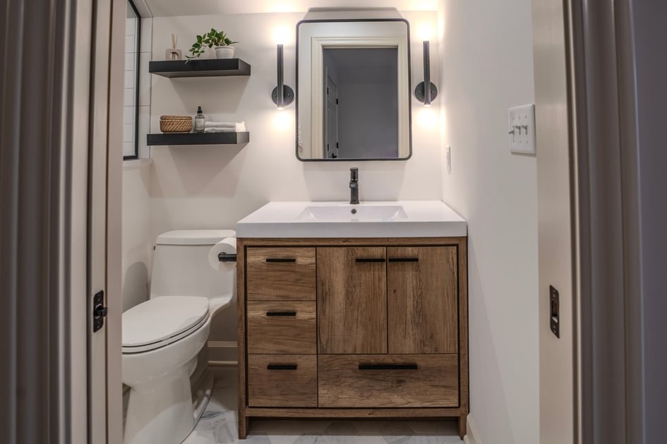A modern white porcelain toilet stands in a bright, clean contemporary bathroom setting.