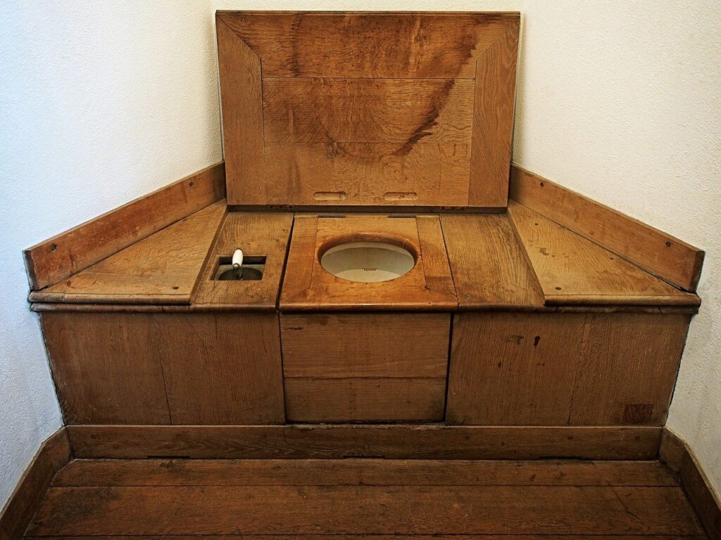 A modern porcelain toilet in a bright, clean, and minimalist residential bathroom.