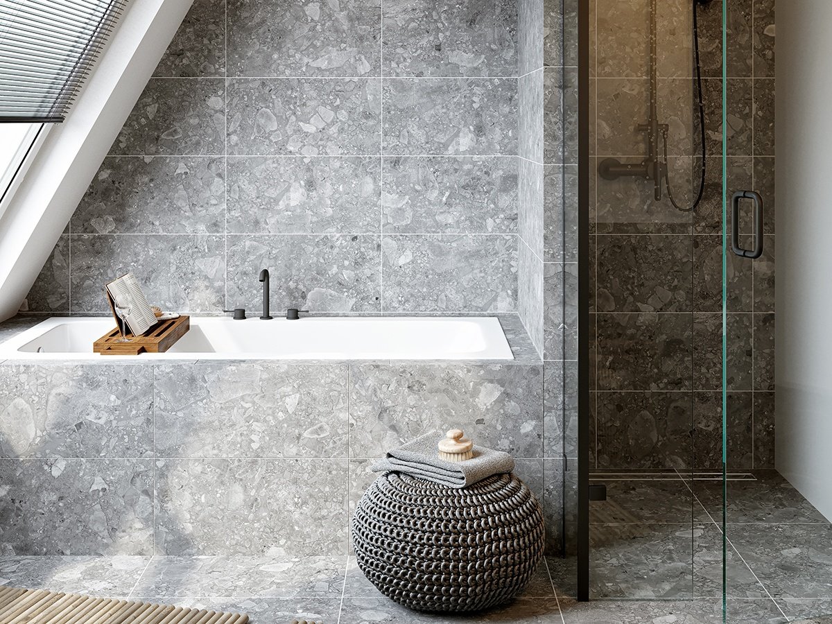 Porcelain and granite tiles laid side by side in a clean bathroom.