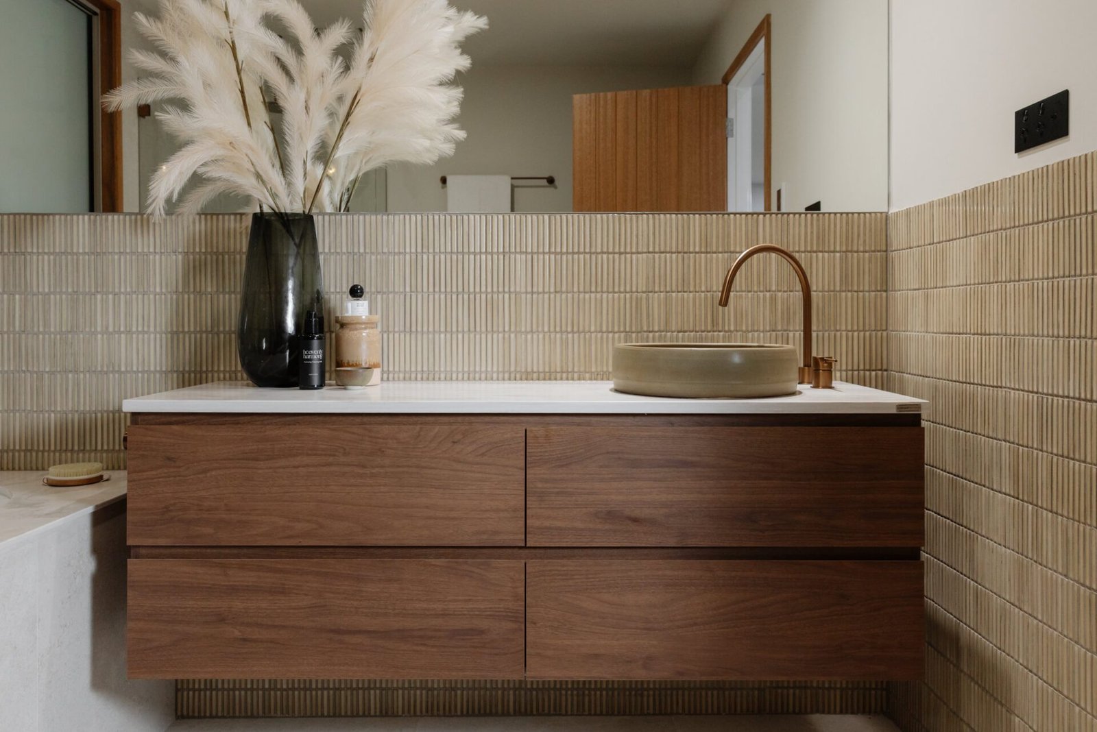 Various bathroom tile samples arranged neatly on a desk for professional review.