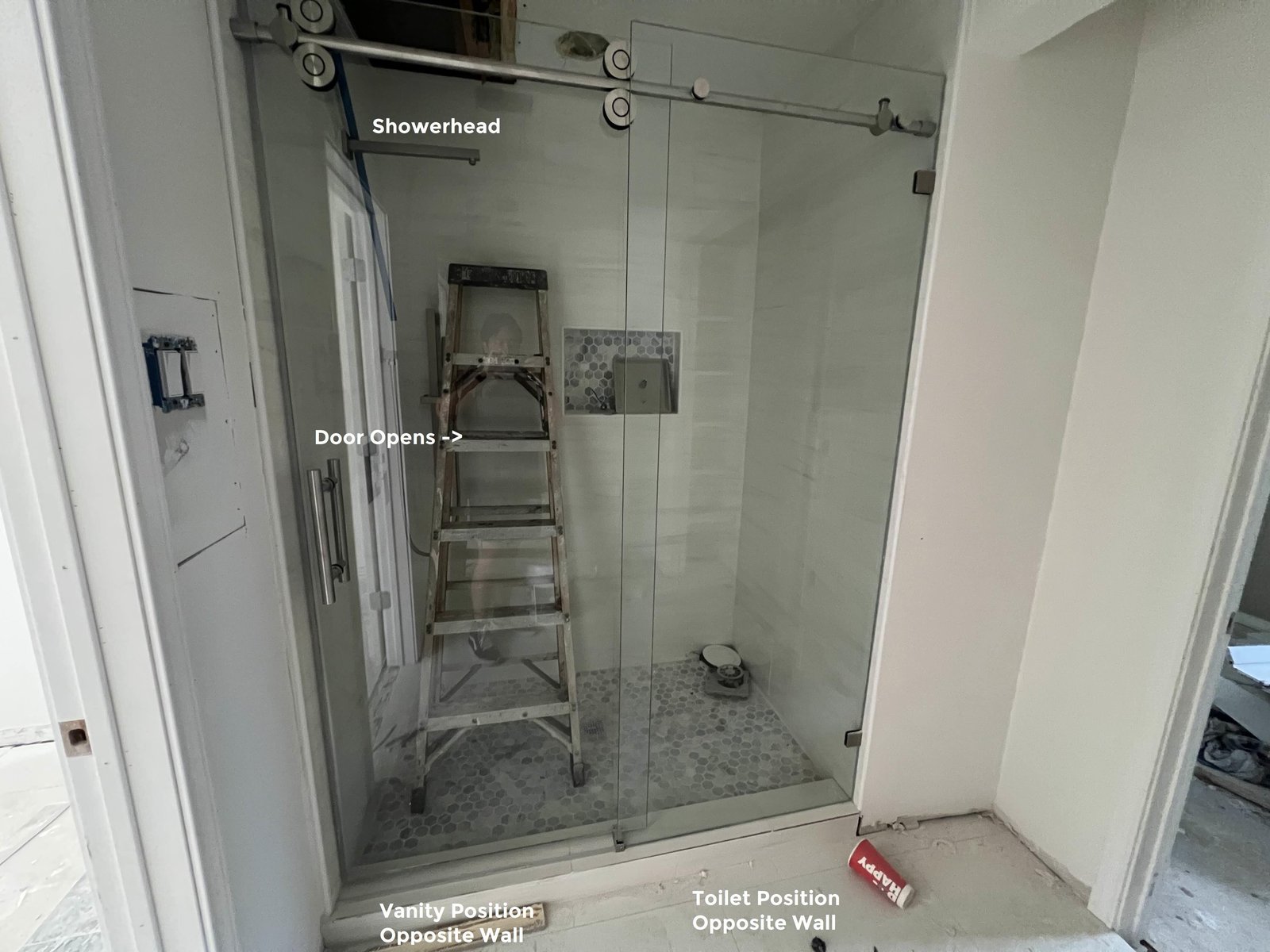 Checking the distance between the shower controls and the door hinge placement.