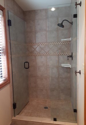 A properly installed glass shower door with a secure seal against the curb.