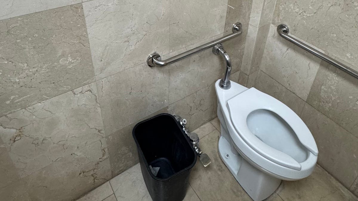 A tidy bathroom shelf with towels, representing common travel questions about plumbing.
